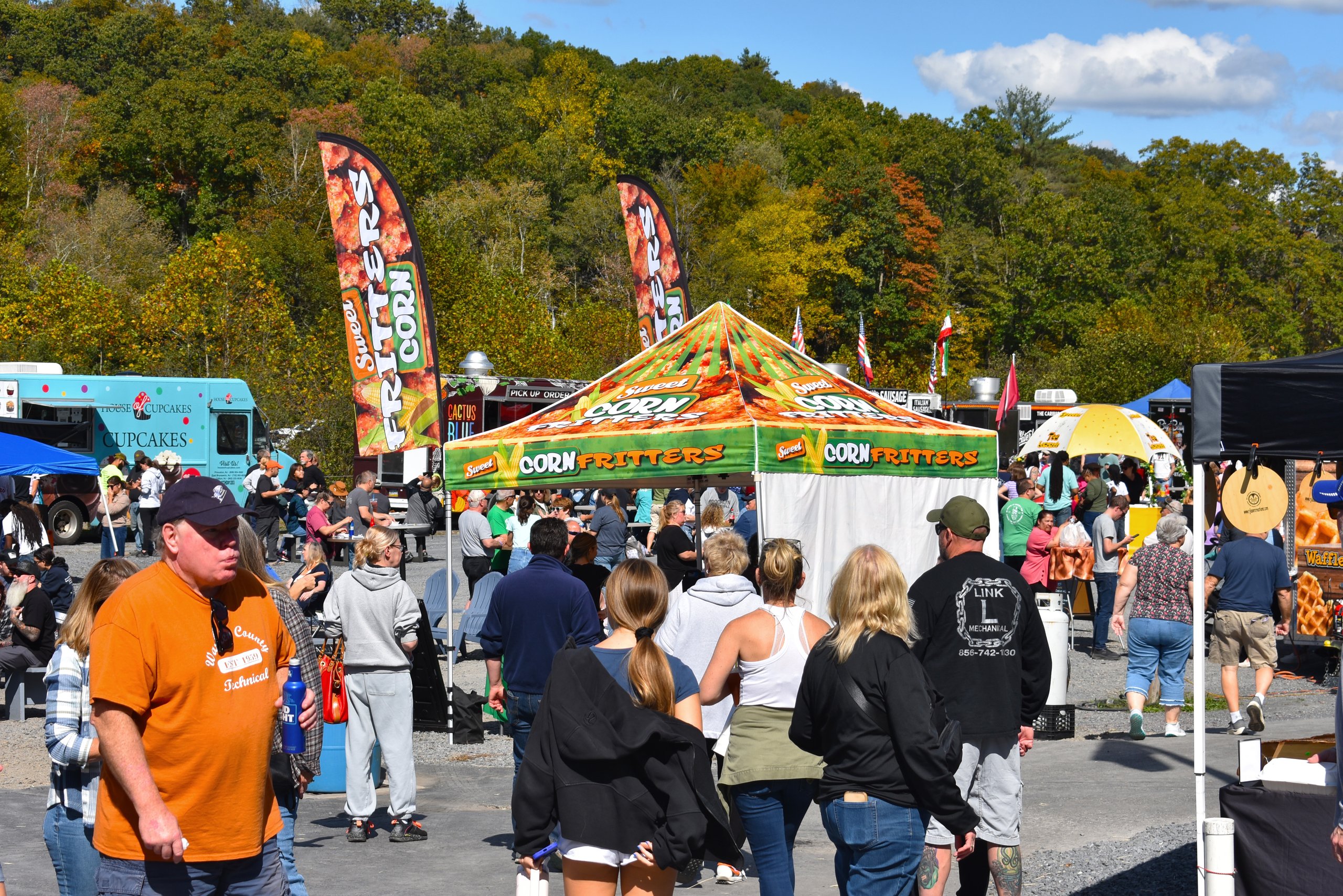 Food truck festival with tents and a lot people