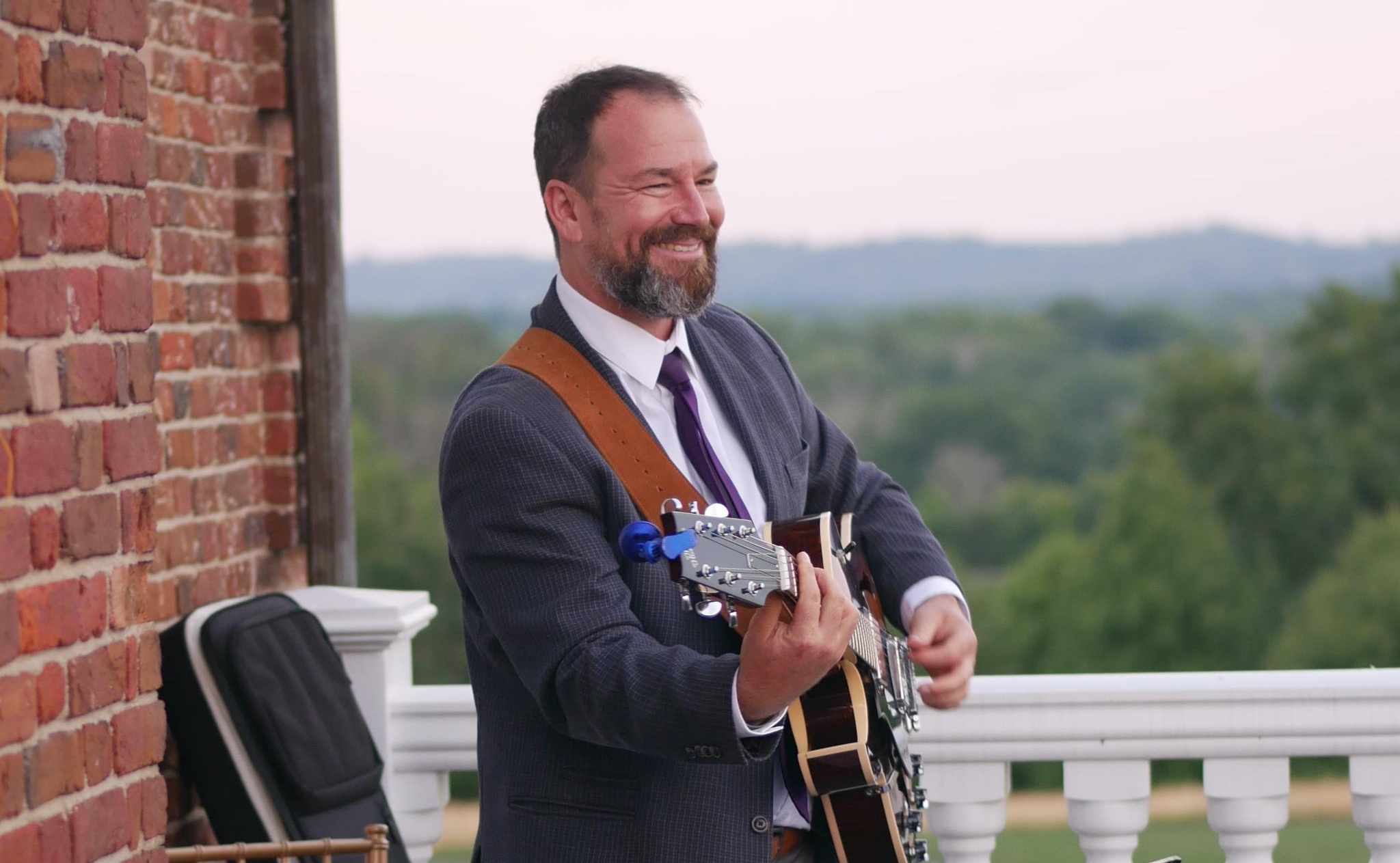 Guy smiling with guitar
