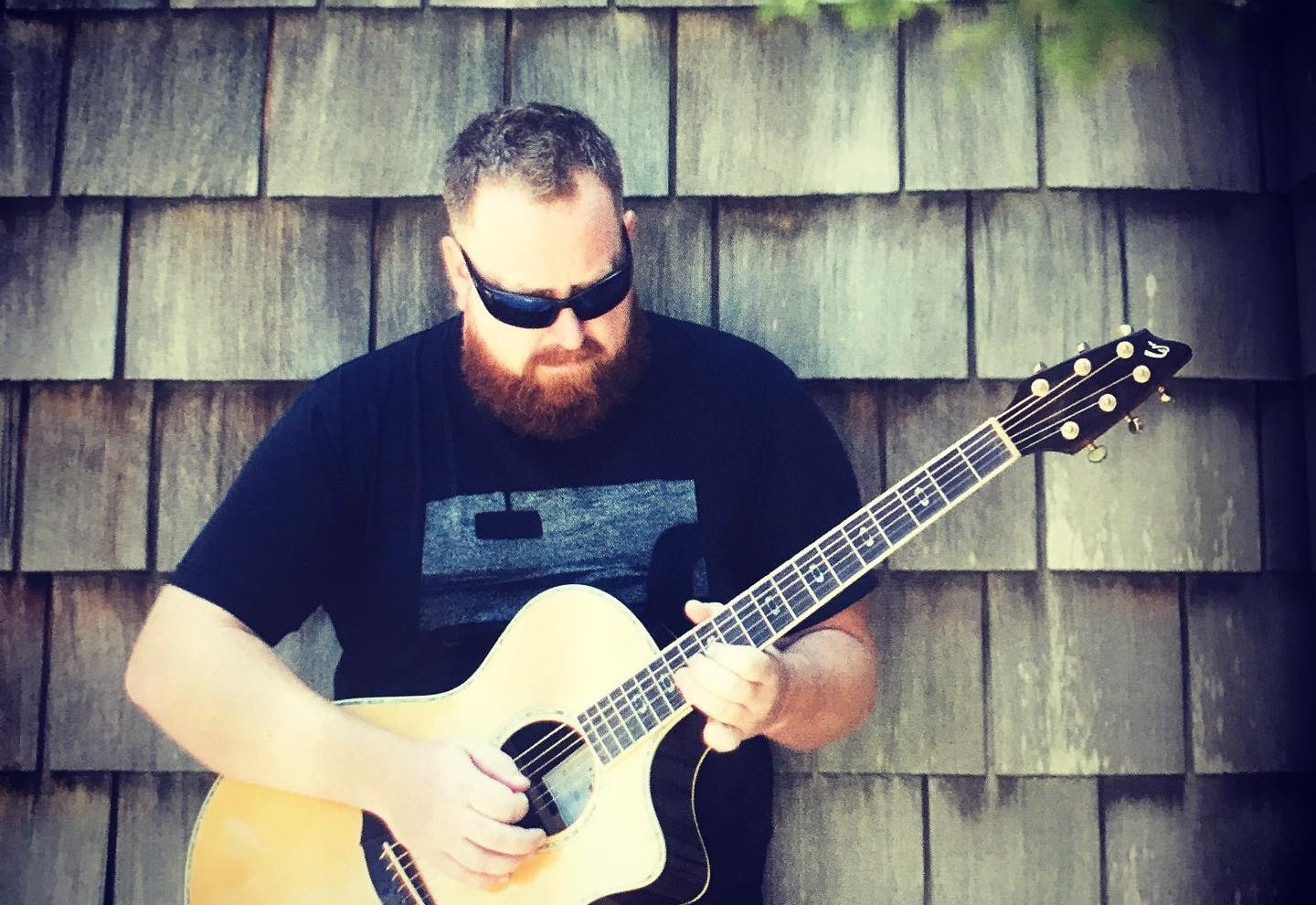 Guy with sunglasses and guitar