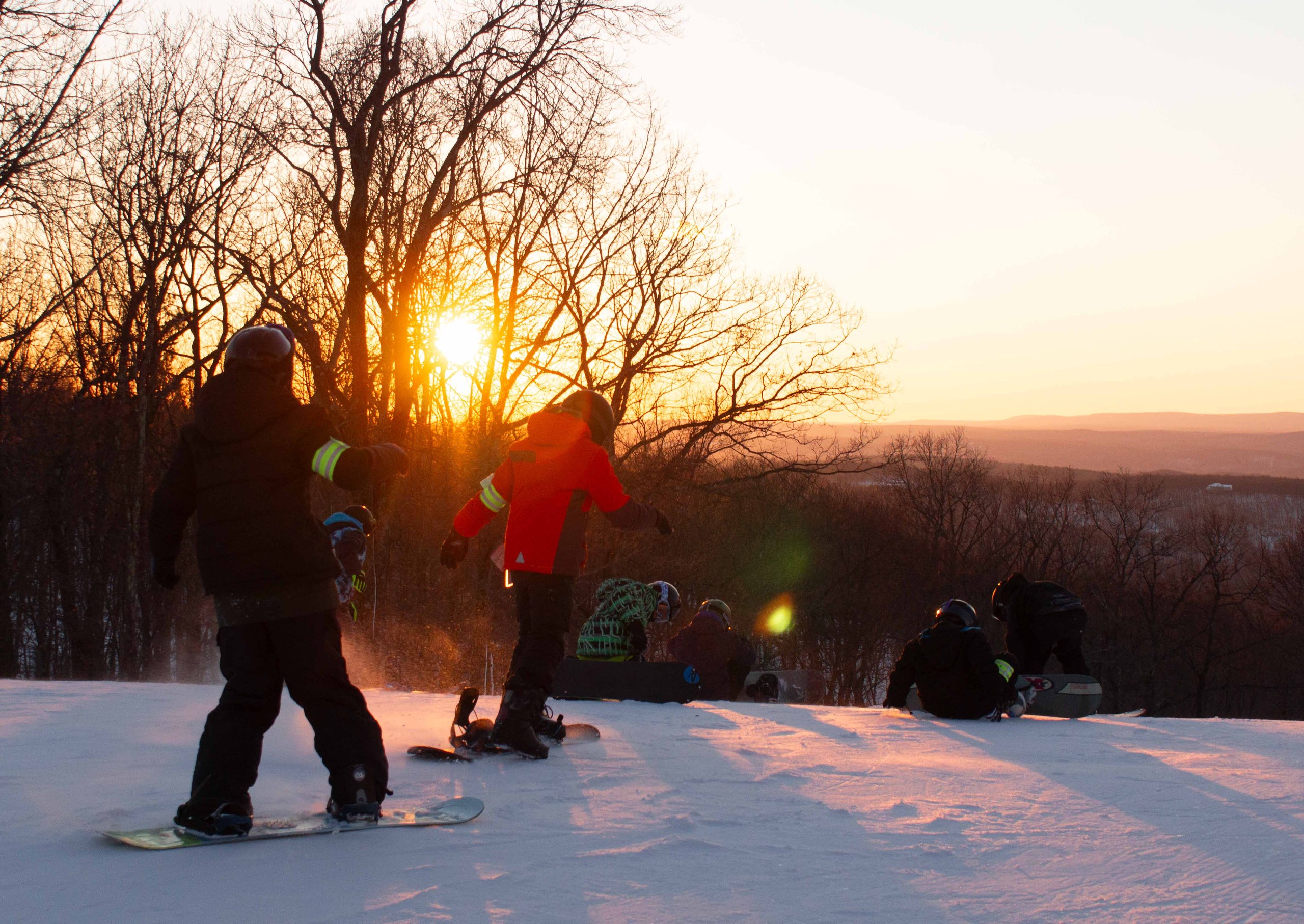 sunset photo with snowboarders