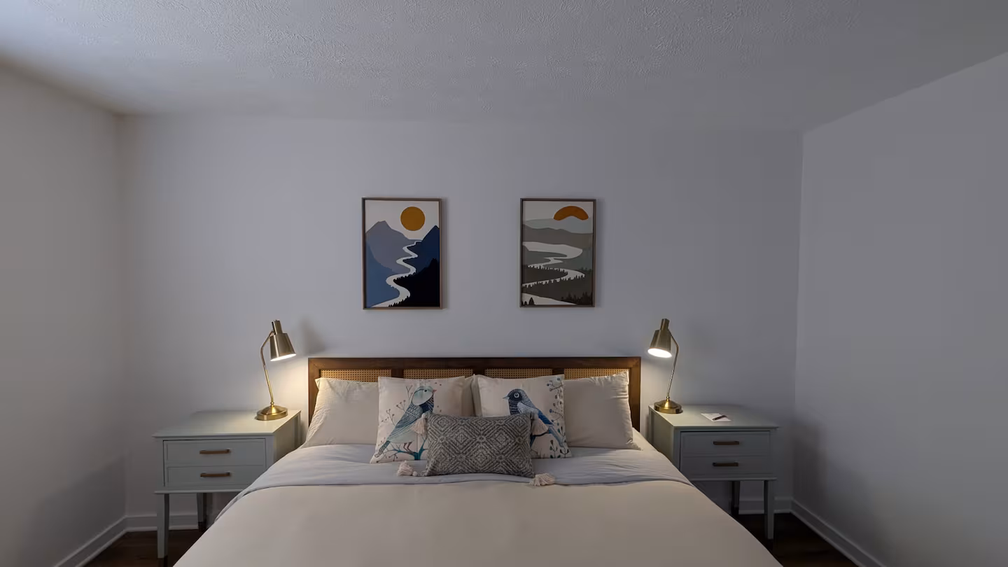 Picture of bed and 2 pictures on wall