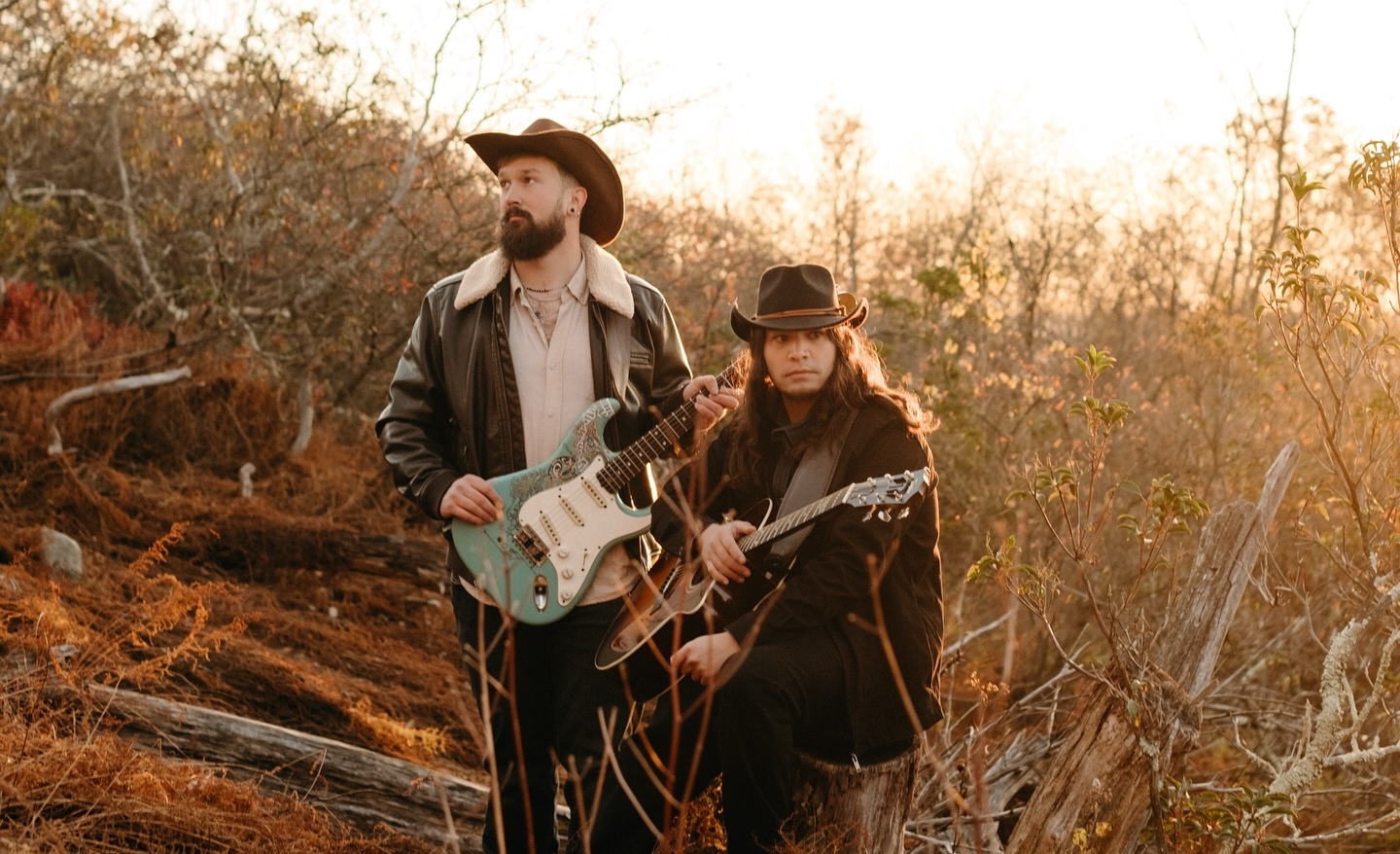 2 guys guitars and hats